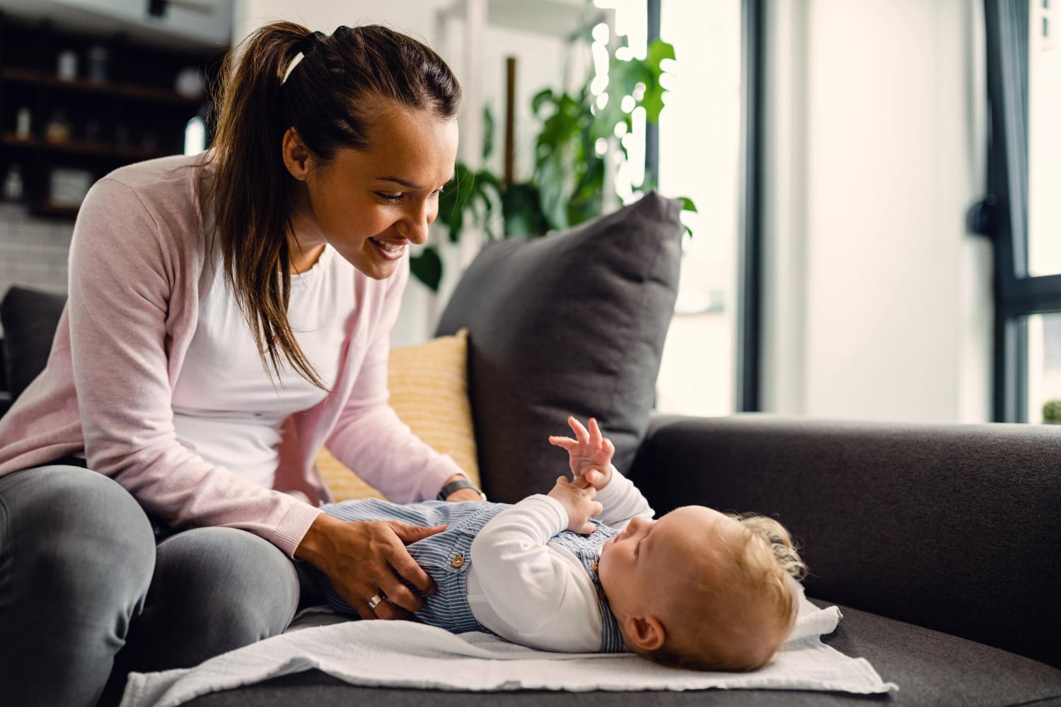 A mother holding her newborn with midwife support